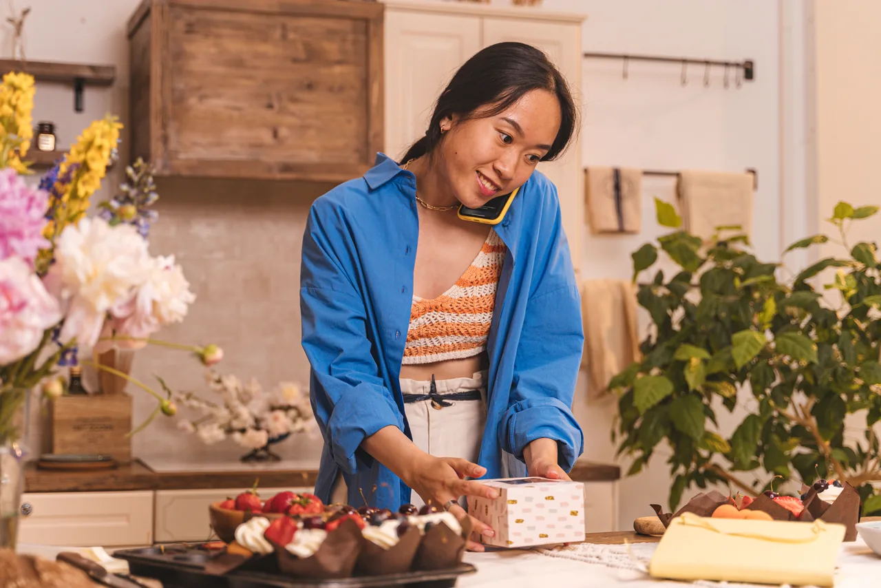 A bakery owner taking an order by phone